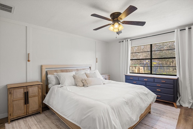 bedroom with ceiling fan and light hardwood / wood-style flooring