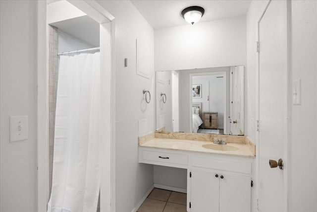 bathroom with a shower with shower curtain, vanity, and tile patterned floors