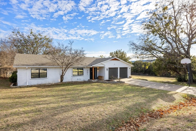 ranch-style house featuring a garage and a front lawn