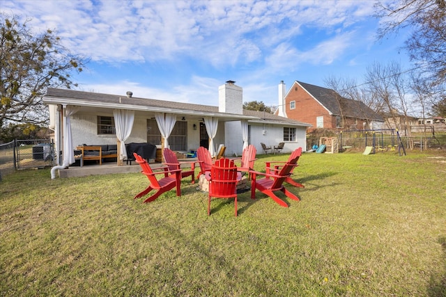 rear view of property featuring a lawn, a patio area, a playground, and central AC