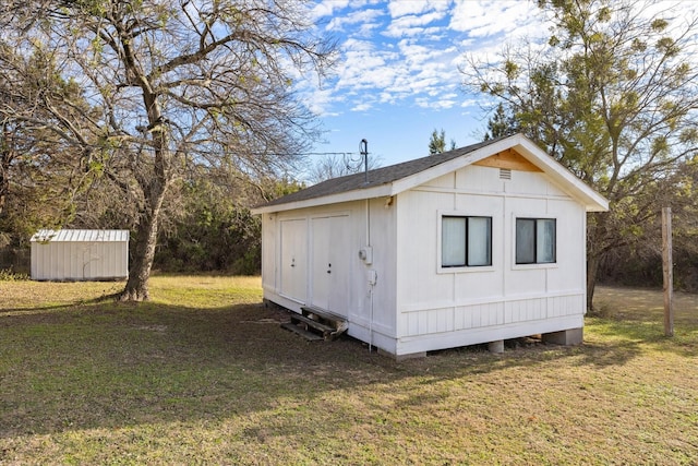 view of outbuilding featuring a lawn