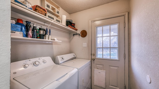 laundry room featuring separate washer and dryer and a textured ceiling