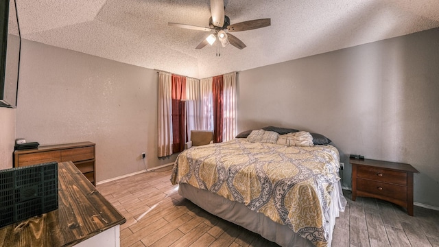 bedroom with ceiling fan and a textured ceiling