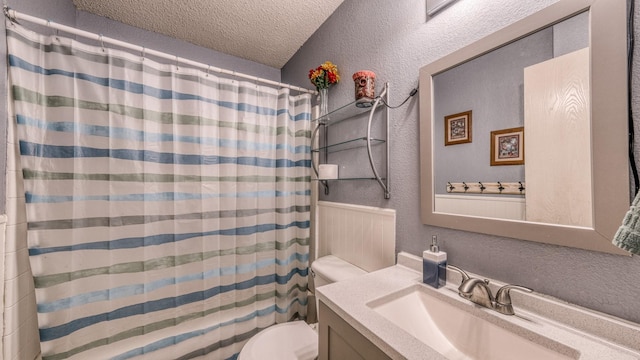 bathroom featuring vanity, toilet, a textured ceiling, and a shower with shower curtain