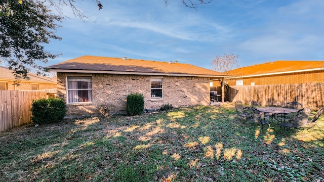 rear view of house featuring a lawn