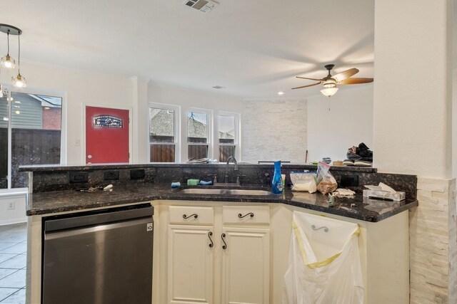 kitchen with dishwasher, decorative light fixtures, sink, and dark stone counters