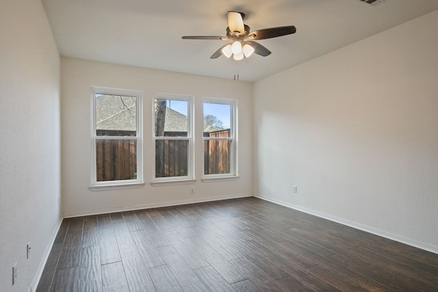 empty room featuring ceiling fan and dark wood-type flooring