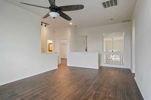 unfurnished living room with ceiling fan with notable chandelier and track lighting