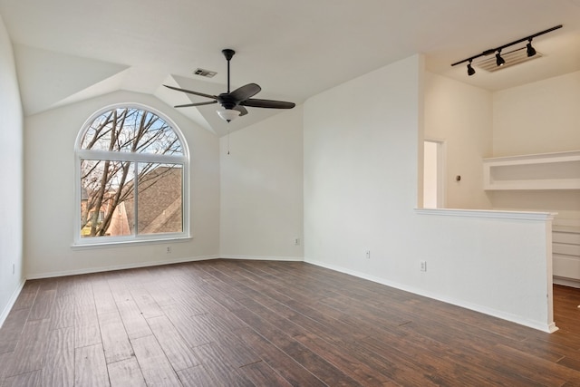 unfurnished living room featuring ceiling fan, dark hardwood / wood-style flooring, rail lighting, and lofted ceiling