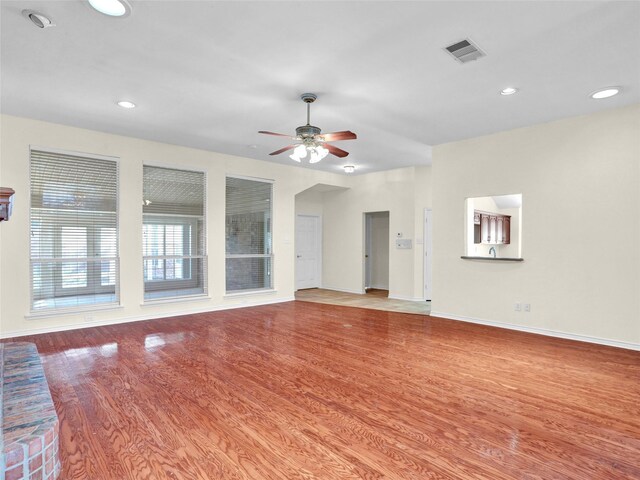 unfurnished living room with light hardwood / wood-style floors and ceiling fan