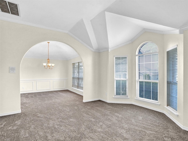 carpeted spare room featuring crown molding, plenty of natural light, a chandelier, and vaulted ceiling