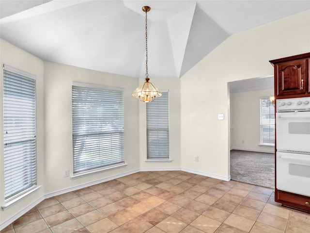 unfurnished dining area featuring a notable chandelier, light tile patterned floors, and vaulted ceiling