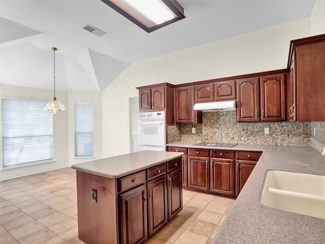 kitchen with white double oven, backsplash, light tile patterned floors, black electric cooktop, and decorative light fixtures