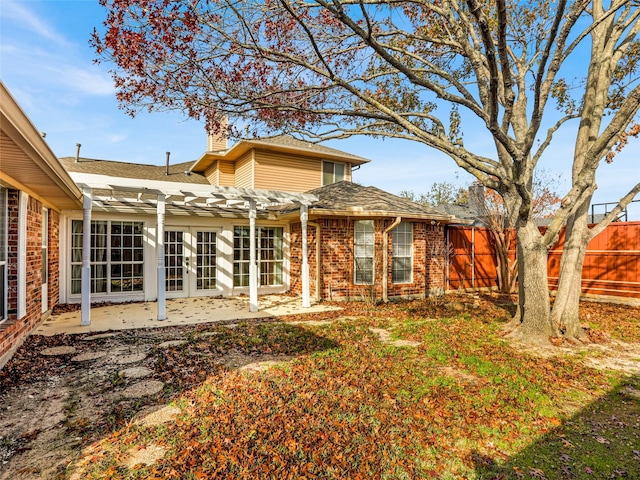 rear view of house featuring a patio area, a pergola, and a yard