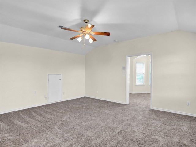 empty room featuring carpet flooring, ceiling fan, and vaulted ceiling