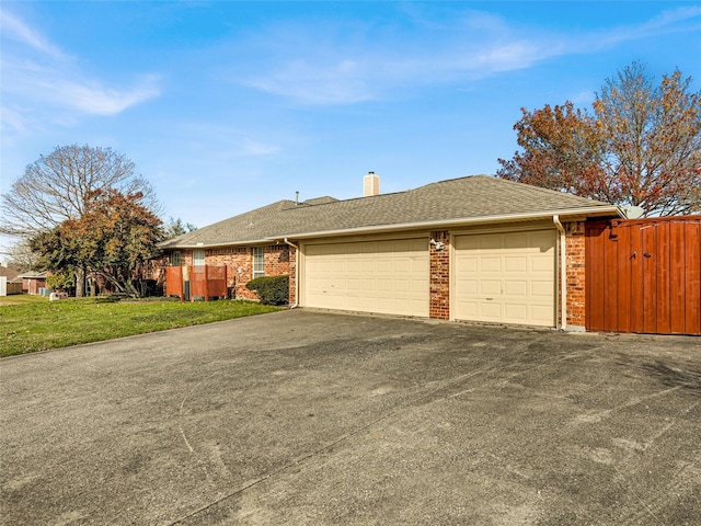 view of front of home with a garage and a front lawn