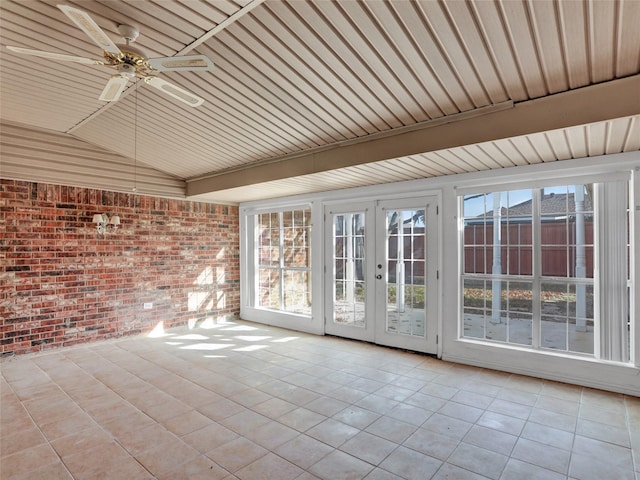 unfurnished sunroom featuring ceiling fan, lofted ceiling, and french doors