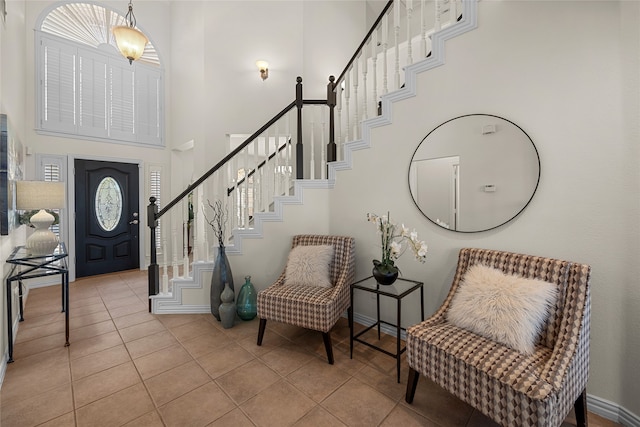 tiled foyer entrance with a high ceiling