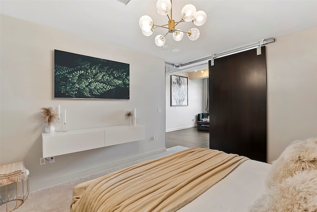 bedroom with an inviting chandelier and a barn door