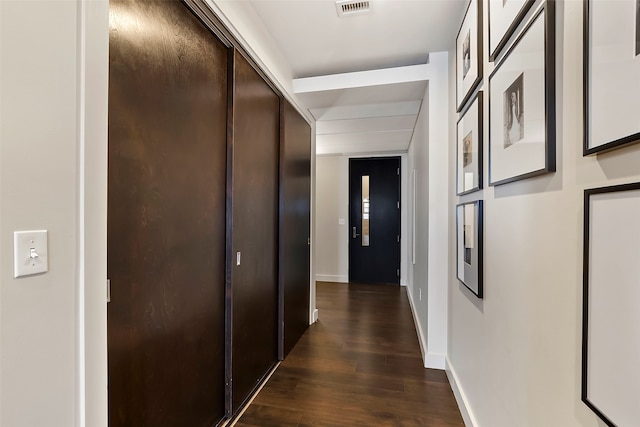 corridor featuring dark wood-type flooring