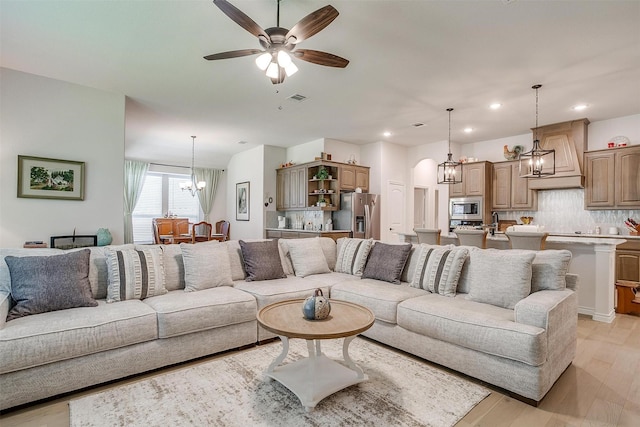 living room with light hardwood / wood-style floors and ceiling fan