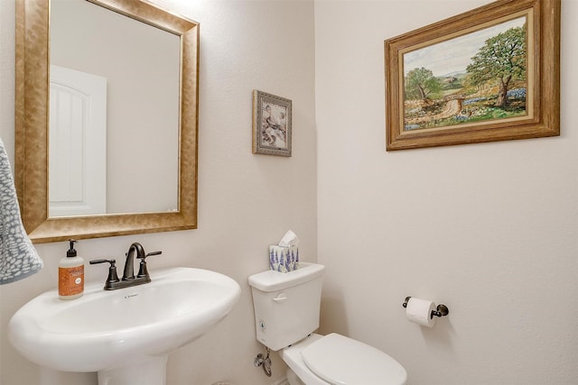 bathroom with toilet and sink