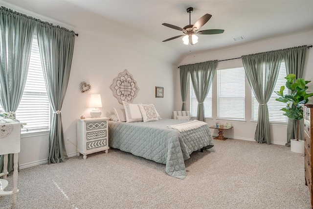 bedroom with ceiling fan, lofted ceiling, carpet floors, and multiple windows