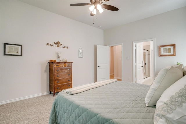 bedroom with ceiling fan, ensuite bathroom, and light carpet