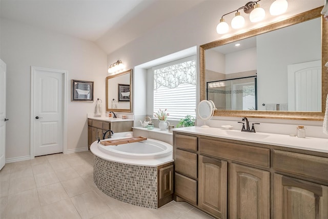 bathroom featuring tile patterned floors, vanity, shower with separate bathtub, and vaulted ceiling