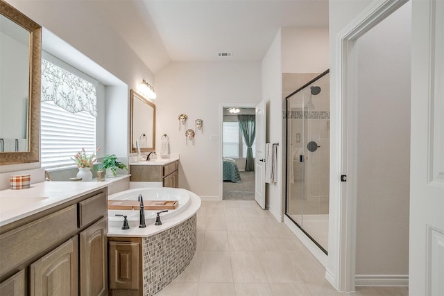 bathroom featuring tile patterned floors, plus walk in shower, and vanity