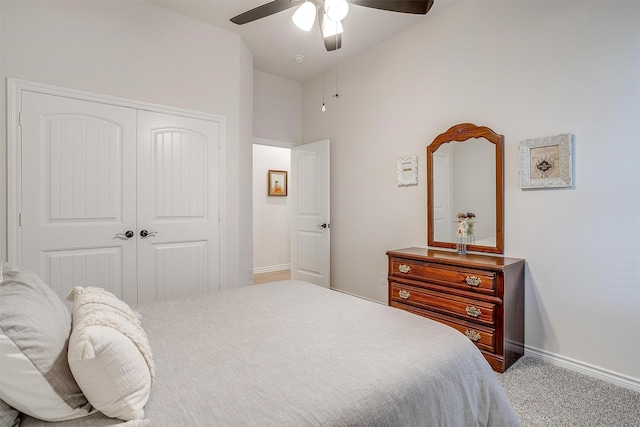 carpeted bedroom with a closet and ceiling fan