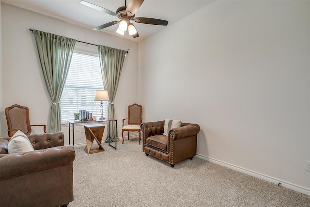 living area featuring ceiling fan and carpet