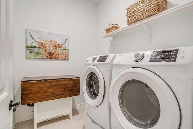 laundry room with light tile patterned flooring and washing machine and clothes dryer