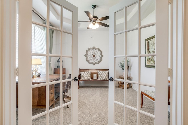 interior space with carpet flooring, french doors, and ceiling fan