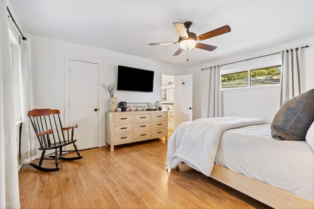 bedroom with light hardwood / wood-style floors, ceiling fan, and ensuite bathroom