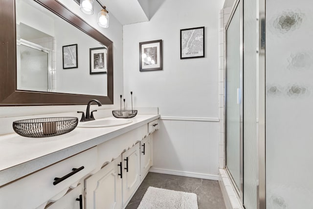 bathroom featuring a shower with door, vanity, and tile patterned flooring