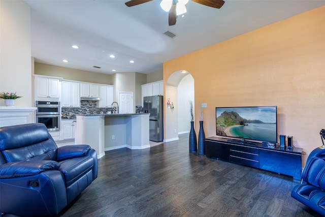 living room with ceiling fan, dark hardwood / wood-style flooring, and sink