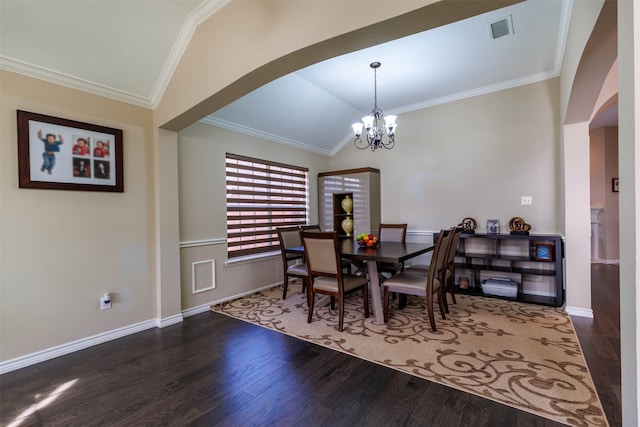 dining space featuring crown molding, a chandelier, lofted ceiling, and hardwood / wood-style flooring