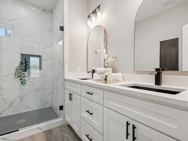 bathroom featuring vanity, wood-type flooring, and an enclosed shower