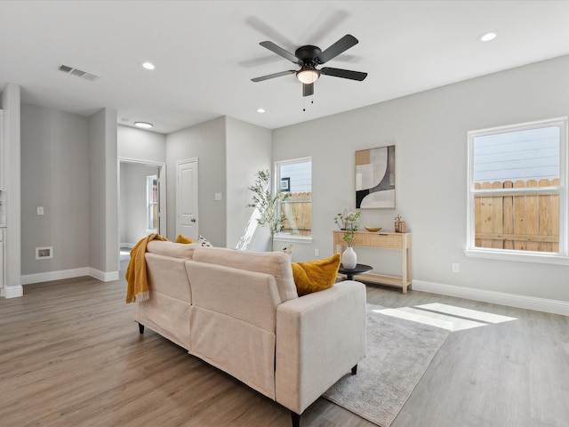 living room with ceiling fan and light hardwood / wood-style floors