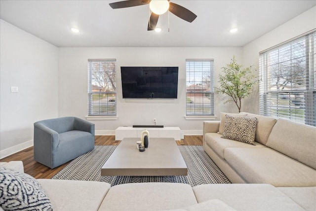 living room featuring hardwood / wood-style floors and ceiling fan