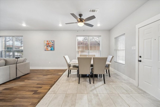 dining room with ceiling fan and light hardwood / wood-style floors