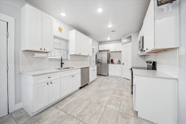 kitchen featuring sink, white cabinetry, and stainless steel appliances