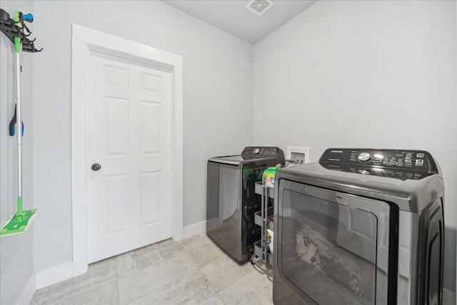 clothes washing area with washing machine and clothes dryer