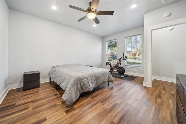 bedroom with ceiling fan and dark wood-type flooring