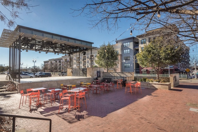 view of home's community featuring a pergola and an outdoor bar