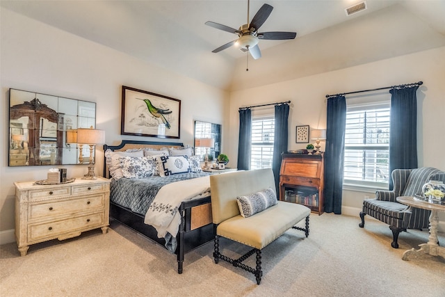 carpeted bedroom with a raised ceiling, ceiling fan, and lofted ceiling