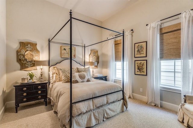 carpeted bedroom with multiple windows