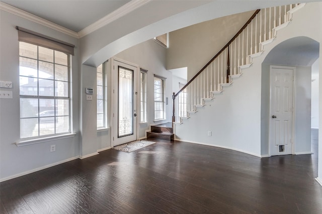 foyer entrance with crown molding and dark wood-type flooring