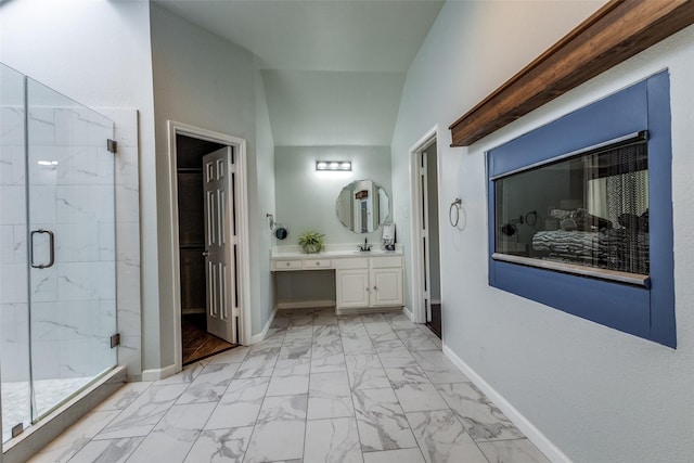 bathroom featuring lofted ceiling, a multi sided fireplace, a shower with shower door, and vanity